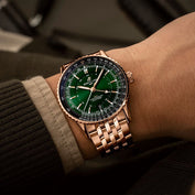 Model wearing Breitling luxury wristwatch with green dial