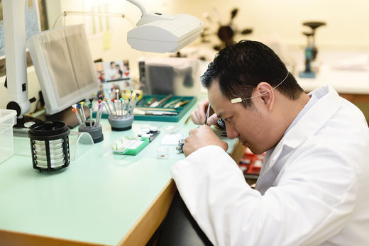 Professional jeweler repairs a watch