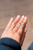 Woman modeling various styles of diamond engagement rings