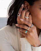 Woman wearing birthstone rings