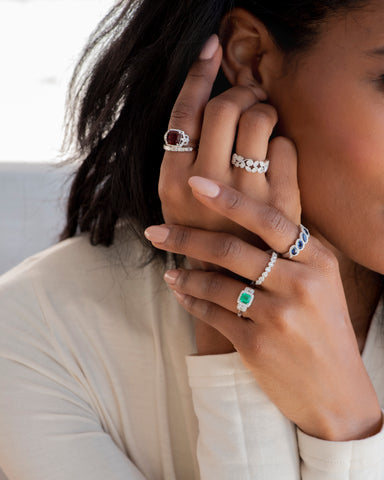 Woman wearing birthstone rings