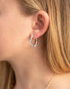 Woman wearing diamond hoops earrings perfect for her face shape