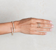 Woman wearing diamond bracelet and stackable rings