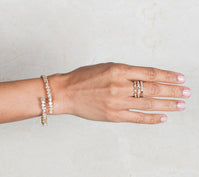 Woman wearing diamond bracelet and stackable rings