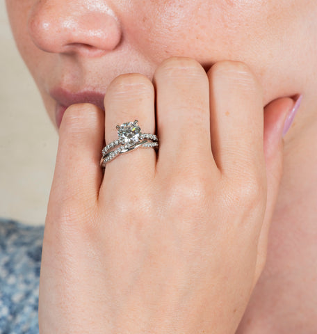 Woman wearing engagement and wedding band ring stack