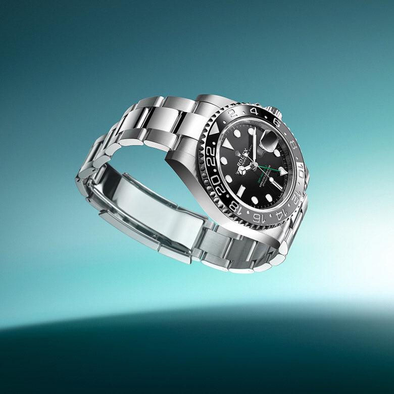 Rolex GMT-Master II watch on a blue green gradient background